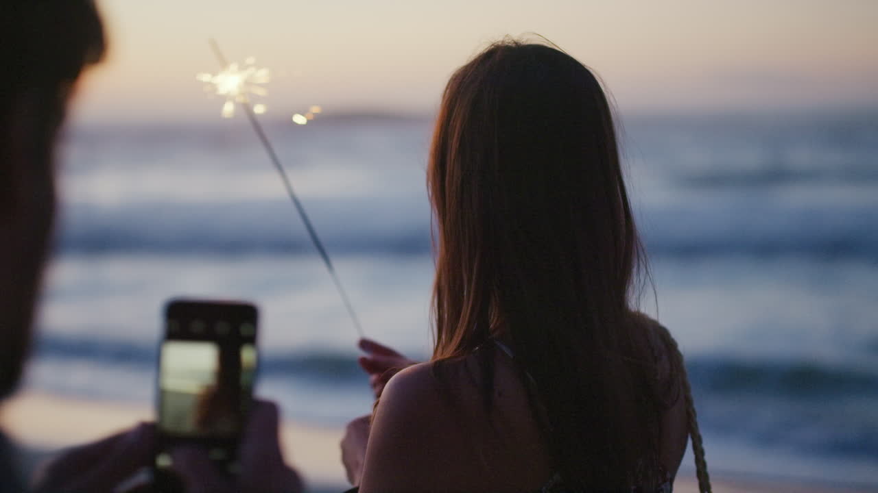 전화, 해변 및 여성 녹화와 함께 스파클러