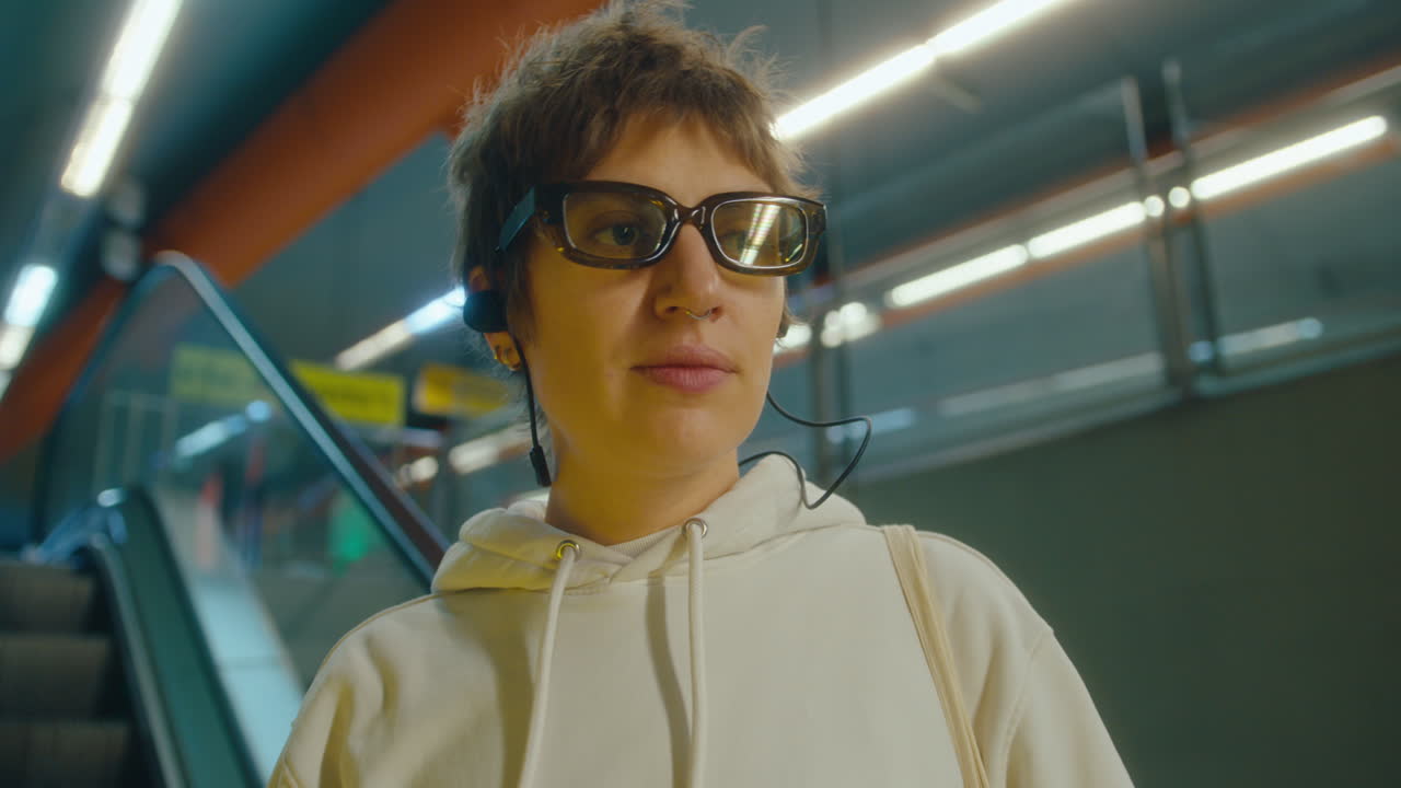 Woman in Earphones Riding Escalator in Underground