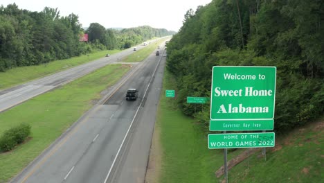 welcome to sweet home alabama sign along highway