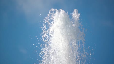 close up shot of water fountain spelling transparent water outdoors in summer