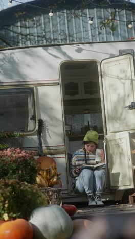 woman relaxing in a camper van at a market