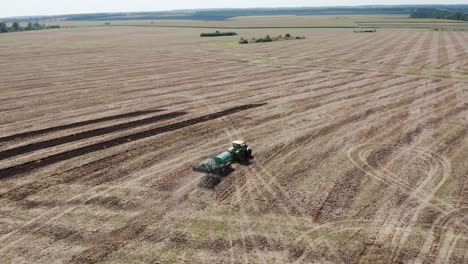 a tractor plowing a dry agricultural field, preparing land for planting. agricultural industry. processing the field on the farm.