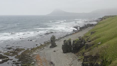 ocean waves in fog seen from coast of strandir in iceland's westfjords