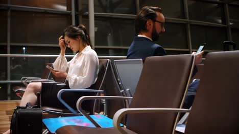 commuters using mobile phone in waiting area 4k