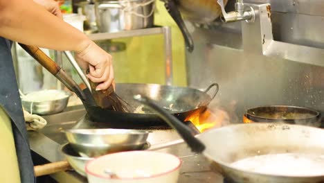 chef skillfully prepares dish over open flame