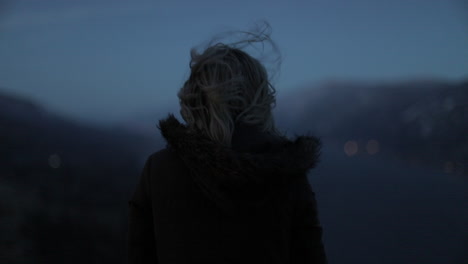 a girl gazes out at a gorge from a scenic viewpoint.