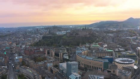 sunset drone view of the city of edinburgh, stunning colored sky in the horizon, copy space
