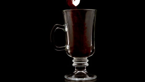 coffee granules pouring into a glass