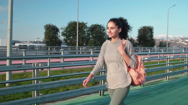 Woman Walking in City Park