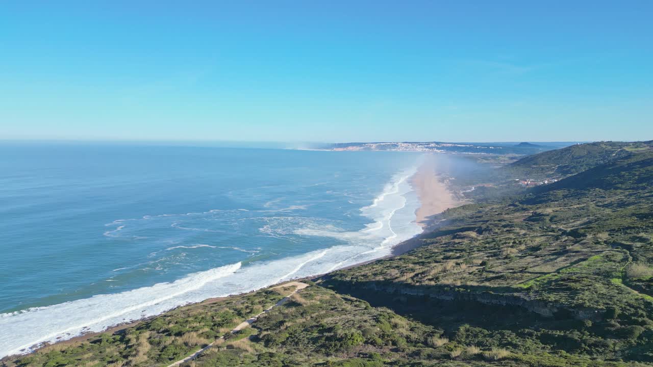 Sweeping aerial view of Miradouro do Salgado and coastline in Nazaré, Portugal