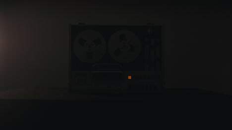 a vintage tape recorder in a pulsing light