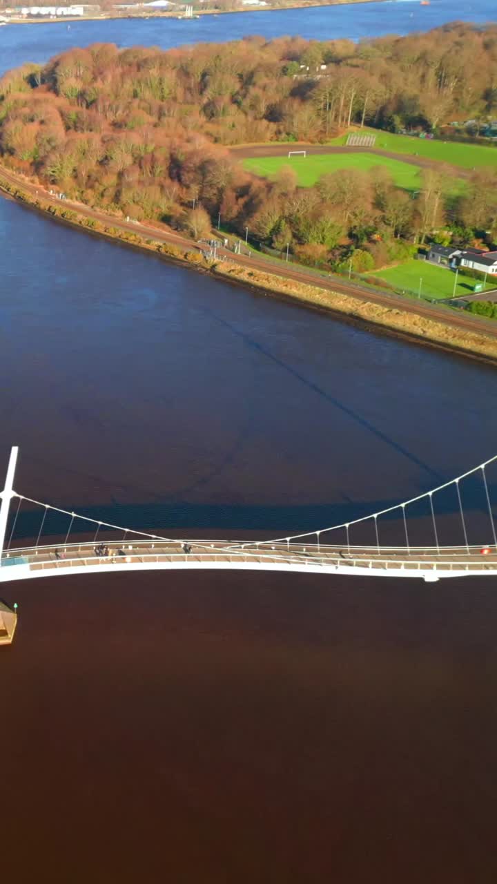 Travelling social ratio aerial of the Peace Bridge over the River Foyle in Derry, AKA Londonderry in Northern Ireland. Filmed in 1080x1920, 60FPS and with Rec709 color