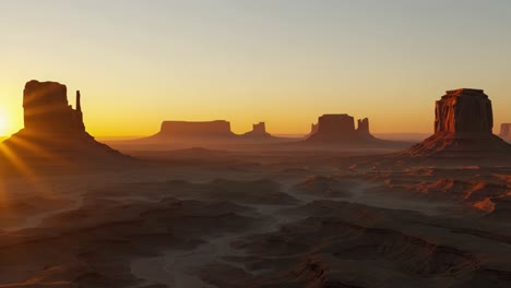 a stunning sunset over desert landscapes: majestic rock formations silhouetted against a golden horizon, capturing the serenity and beauty of nature's wonders