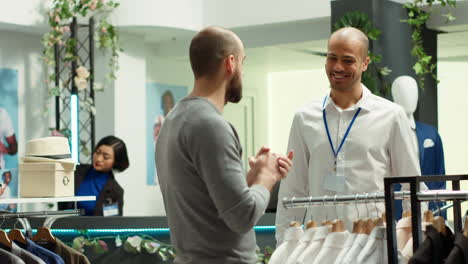 customer discussing clothes with sales associate in a retail store