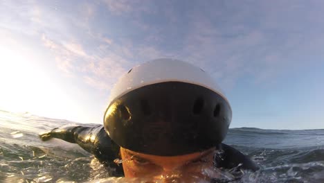 surfer failed takeoff in costa da caparica beach, portugal with huge sun reflexions