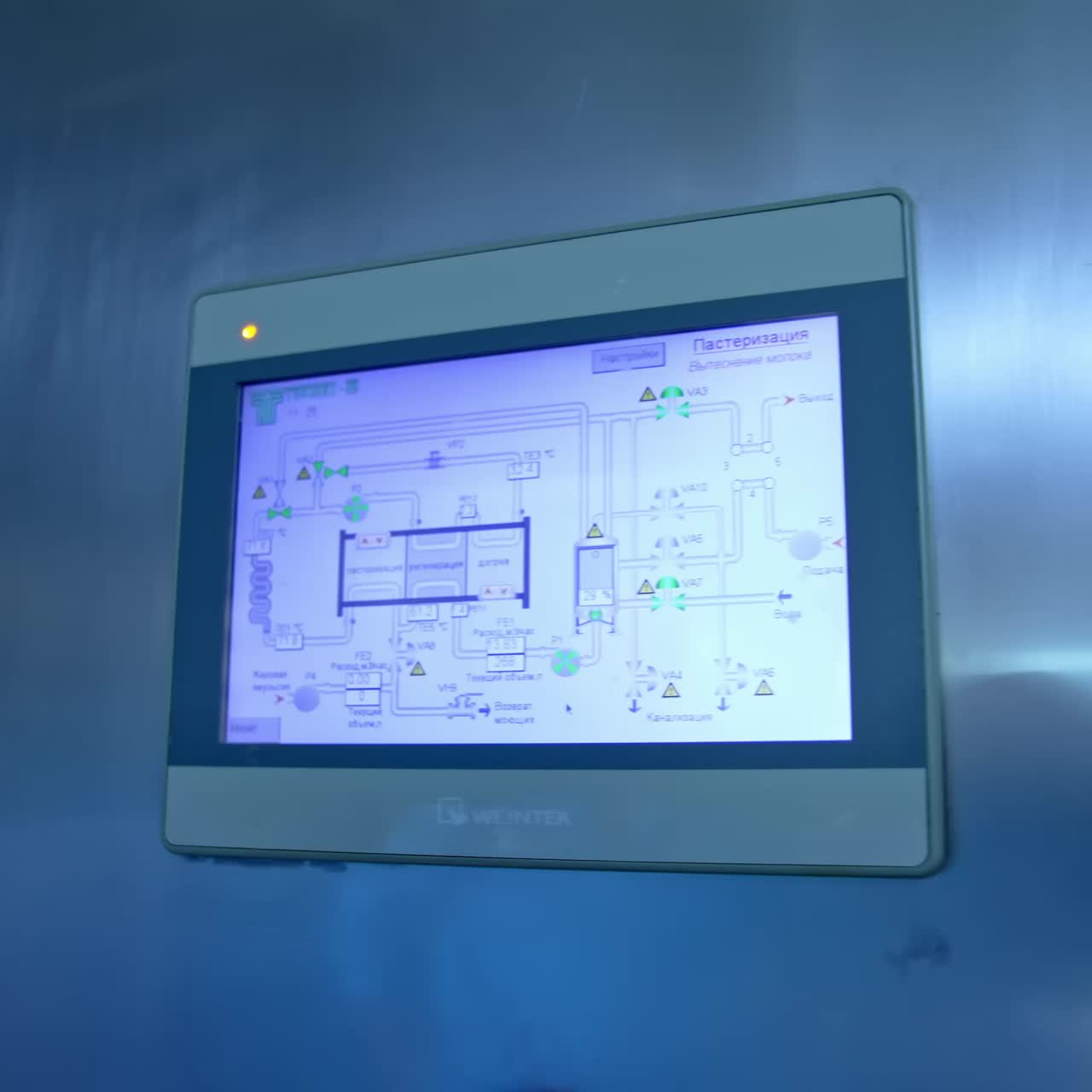 Manufacturing of dairy based products at the factory. Screen on the metal box controller. Equipment for food factory