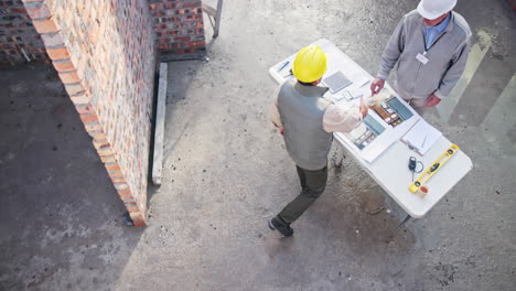 Construction workers reviewing plans at a building site