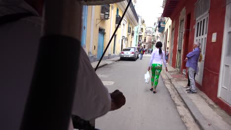 pov from a pedicab taxi moving through the old city of havana cuba