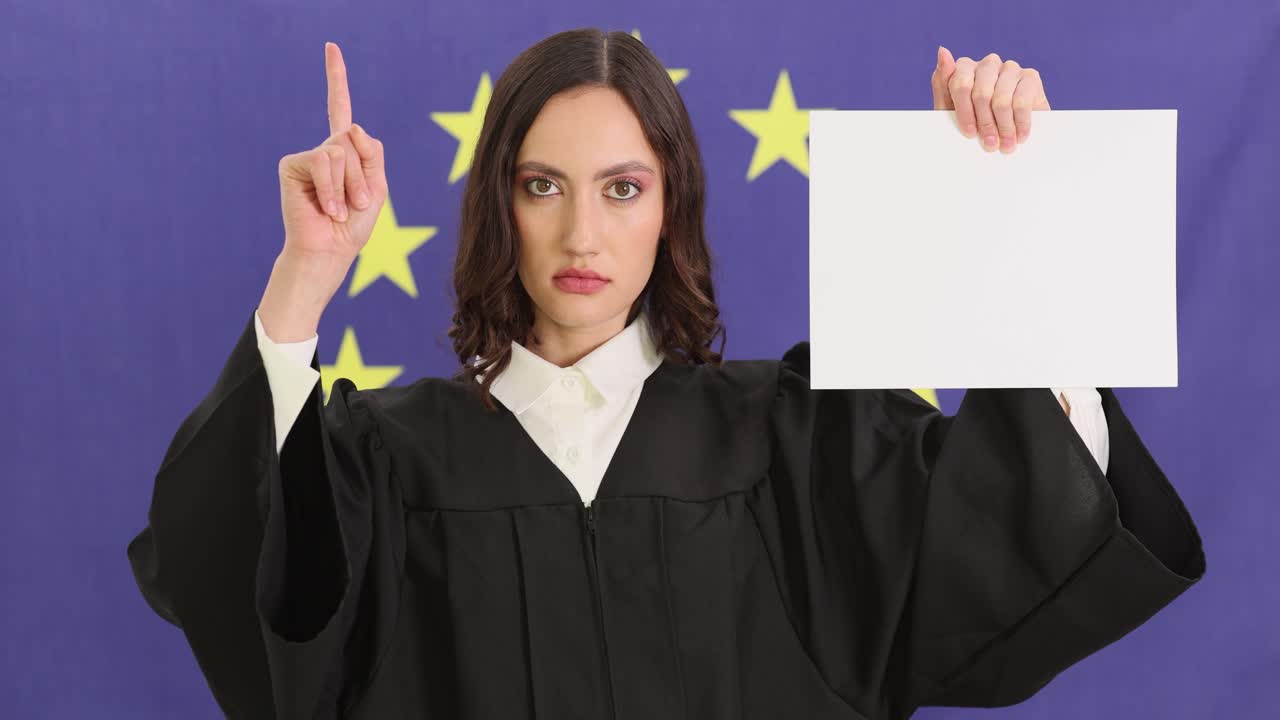 Woman in judicial gown holding blank sign in front of European Union flag