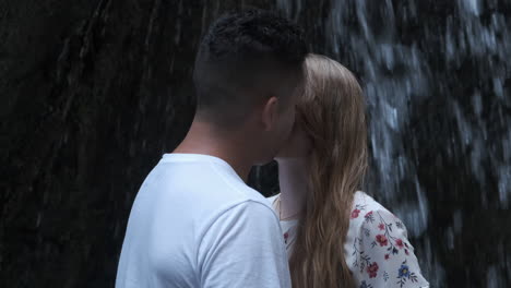 romantic couple embracing by a waterfall