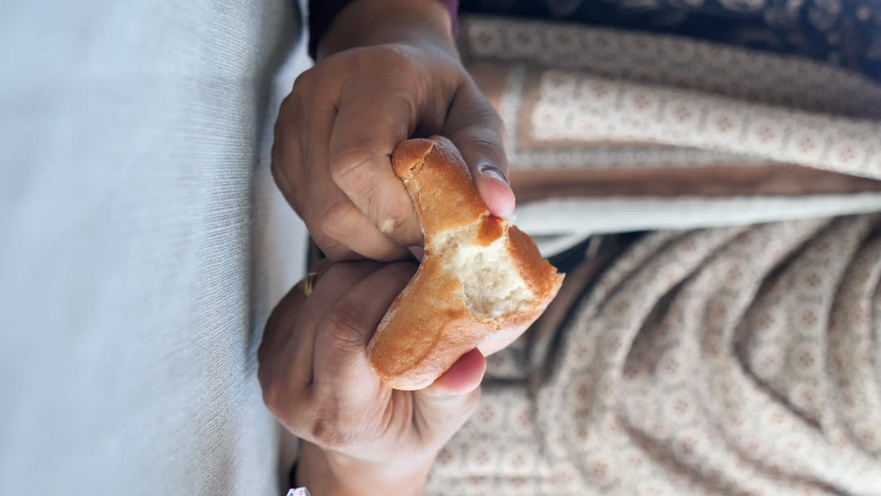 Hands holding a piece of bread