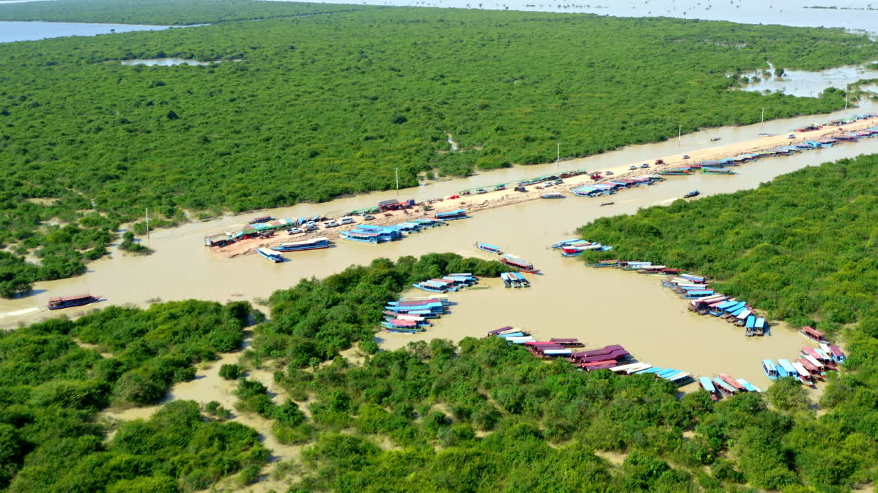 Aerial Flyover Of Cambodia's Floating Village, Boats And Mangroves.