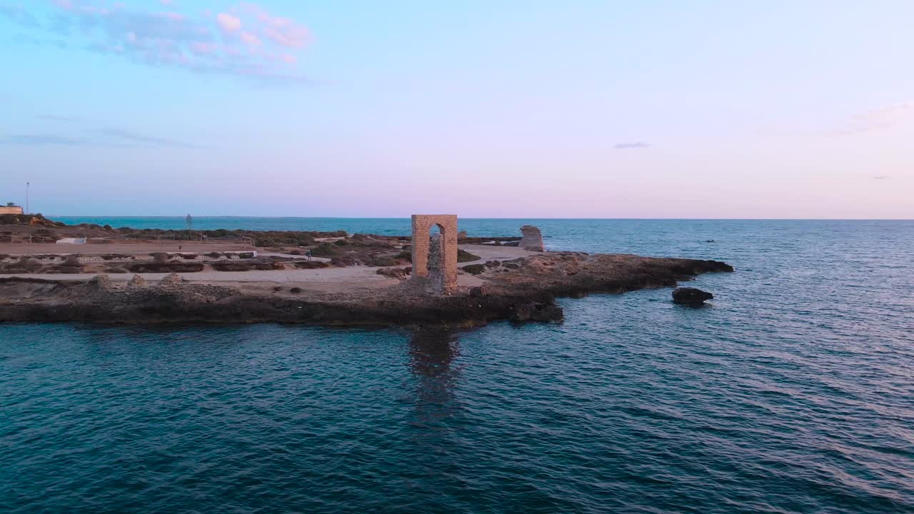Aerial View of Ruins and Lighthouse on a Coastal Island at Sunset