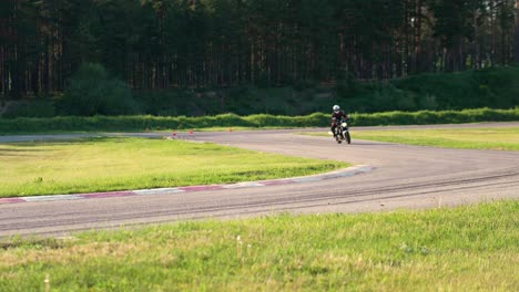 motorcyclists on race track in the forest, moto sport scene, handheld