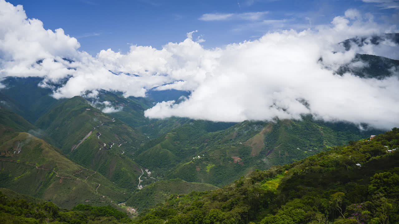 Timelapse in Bolivia Andes Mountains scenery, of clouds clearing and weather moving to reveal valley and Amazon rainforest landscape of Bolivian area of South America
