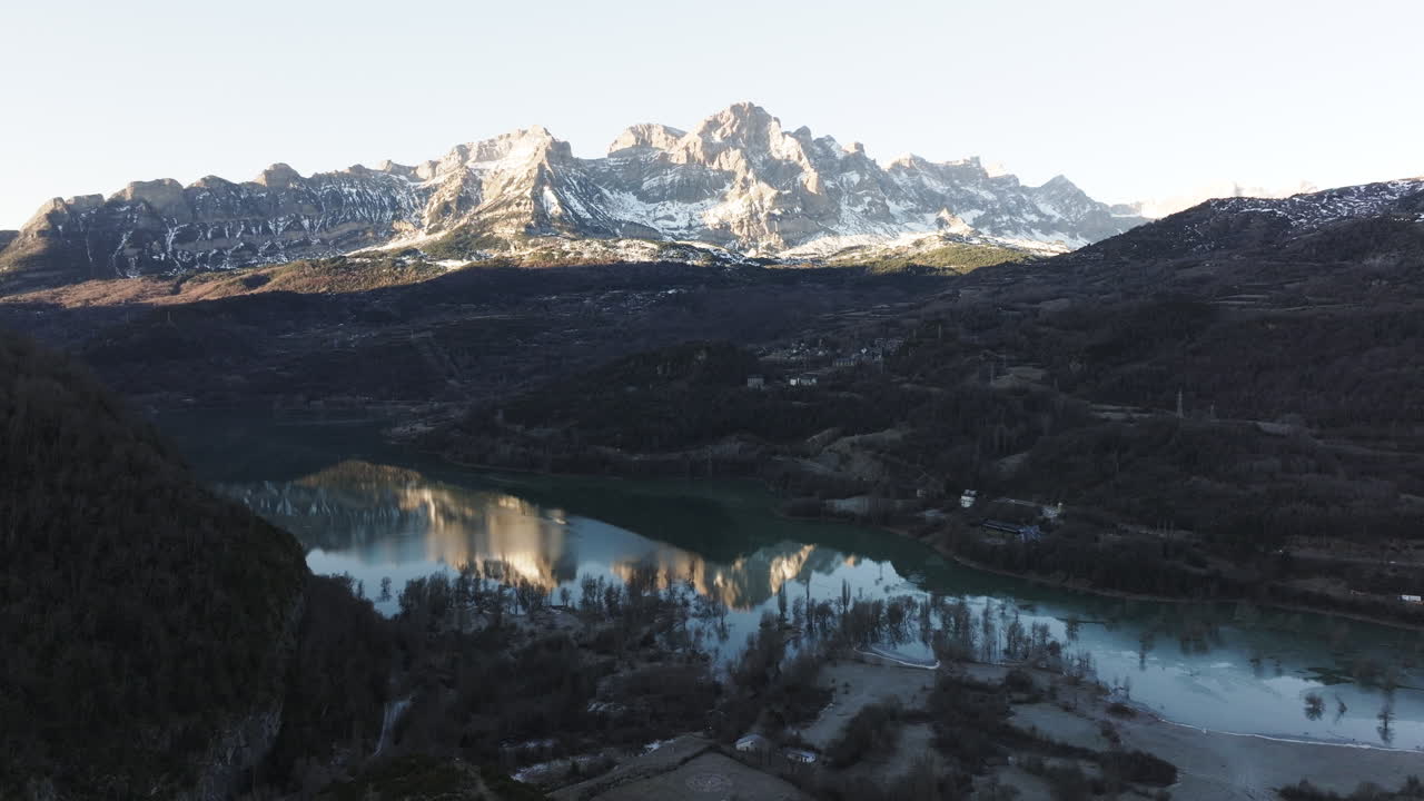 Winter Mountain Landscape with Snow-capped Peaks and Reflected in a Calm Lake
