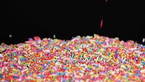 vibrant sprinkles cascade onto a pile