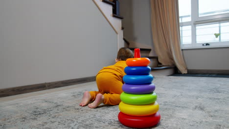 baby playing with stacking rings toy