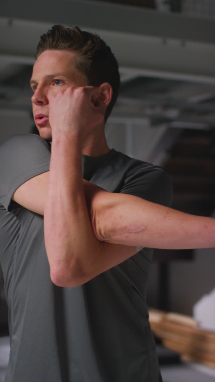 Vertical Video Of Determined Male Athlete Sport Training In Gym Standing And Warming Up In Changing Room With Focused Expression 3