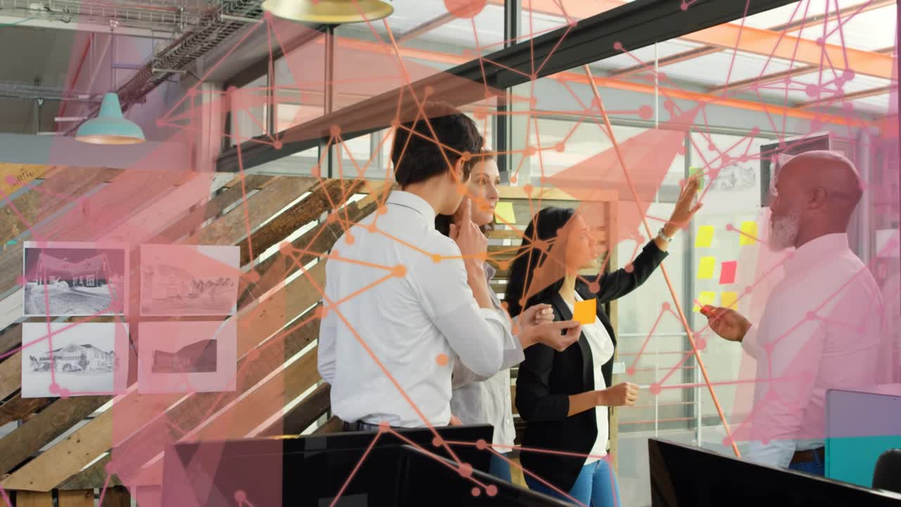 Lead man placing post-its on glass, team arranging plan for project, pink overlay obscuring parts