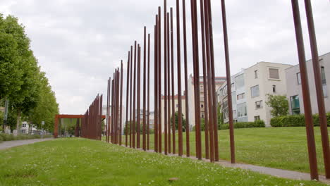 memorial of berlin wall at bernauer strasse with symbolic poles as border