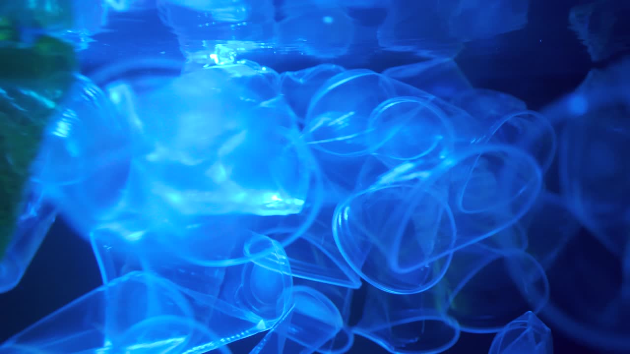 Plastic bottle floating in the arctic ocean sea.Bottle falling down loop of slow motion in background.Video 4K Resolutions.