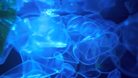plastic bottle floating in the arctic ocean sea.bottle falling down loop of slow motion in background.video 4k resolutions.
