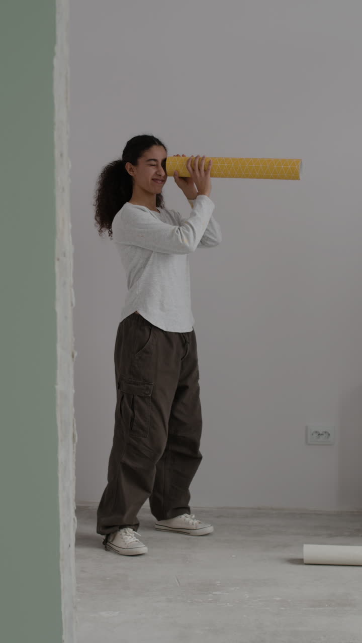 Young Couple Decorating Their New Home with Wallpaper