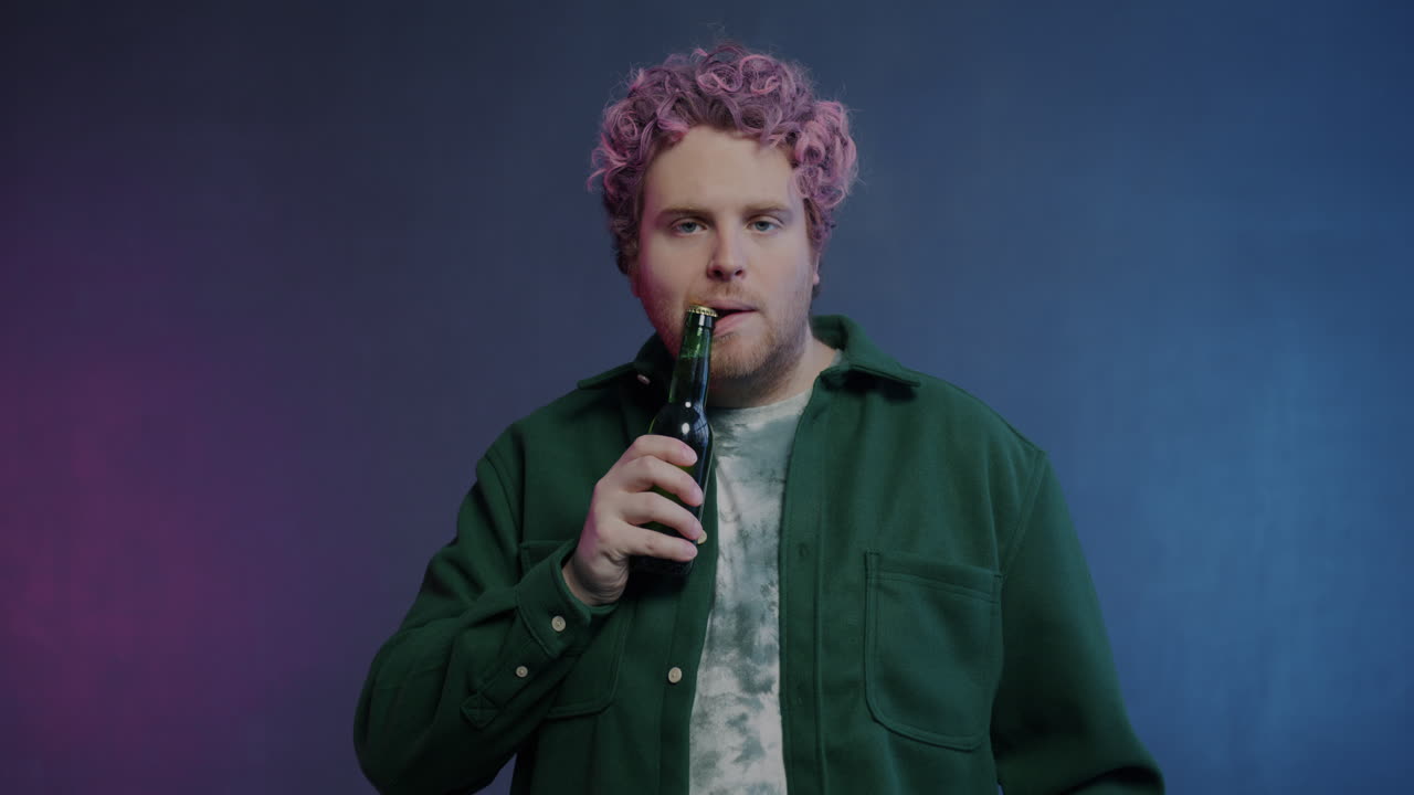 Man Drinking Beer in Studio