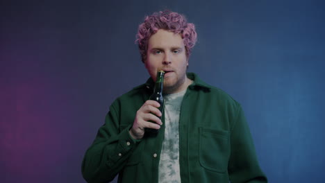 man drinking beer in studio