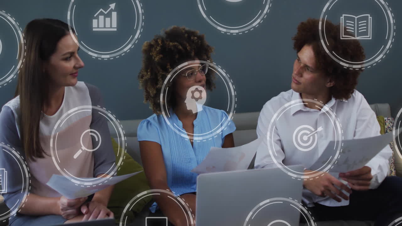 Discussing documents, business team with digital animation icons overlaying scene