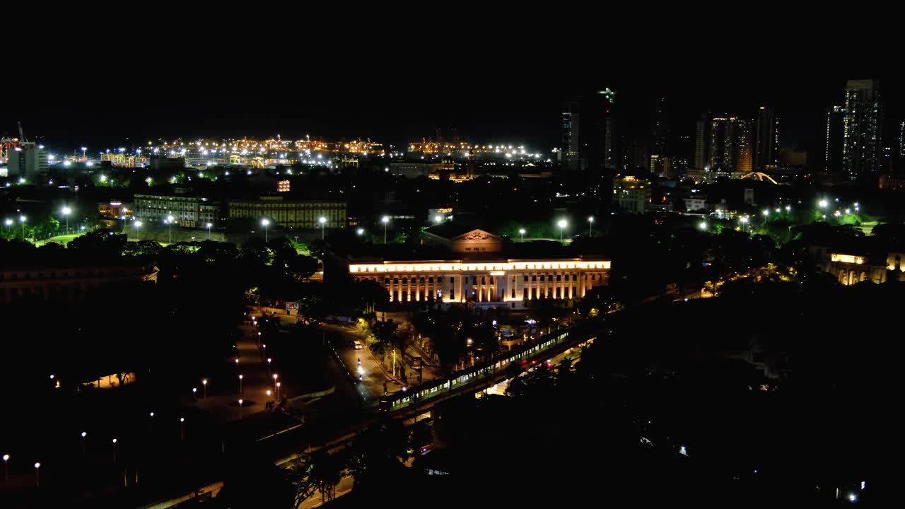 Aerial cityscape view of capital city of Manila Philippines lit up with lights at night