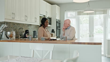 senior man with caregiver in kitchen
