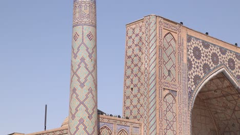 tall minaret with detailed blue tiling in samarkand, uzbekistan along the historic silk road