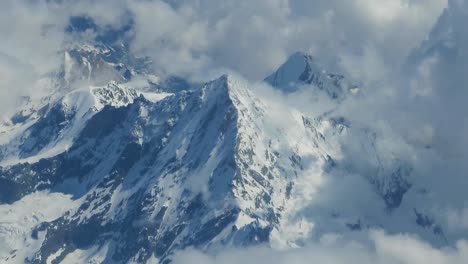 Majestic-Swiss-mountain-peaks,-towering-above-clouds