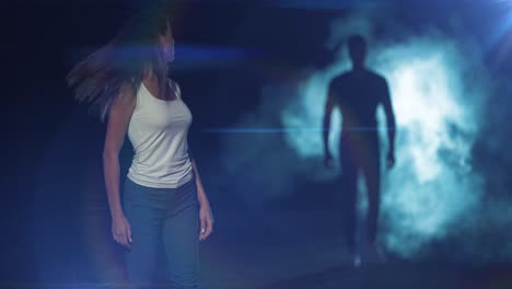 the woman walking in a dark street against a man in a smoke background