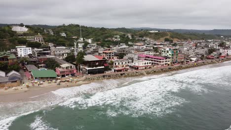 aerial orbit at high tide in montanita ecuador beach town. surfing towns in ecuador. vacation beach destinations.
