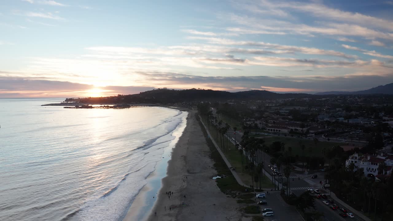 Aerial wide rising shot of East Beach during sunset in Santa Barbara, California. 4K