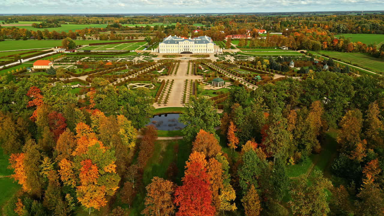 Aerial of Rundale Palace Museum grounds with autumn maple trees changing color, Latvia
