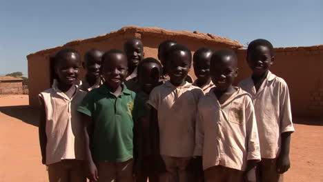 group of happy children waving in a rural village